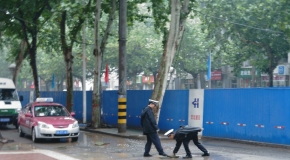 【全民拍客】交警冒雨修补坑洼路面保道路畅通